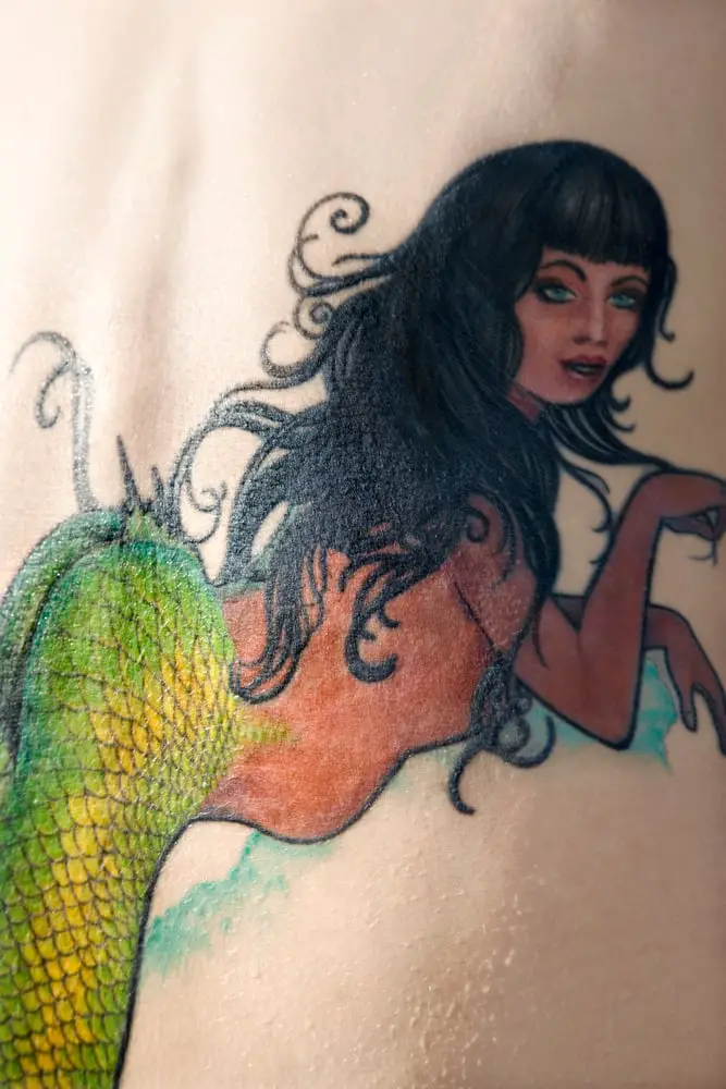 colorful back tattoo of mermaid