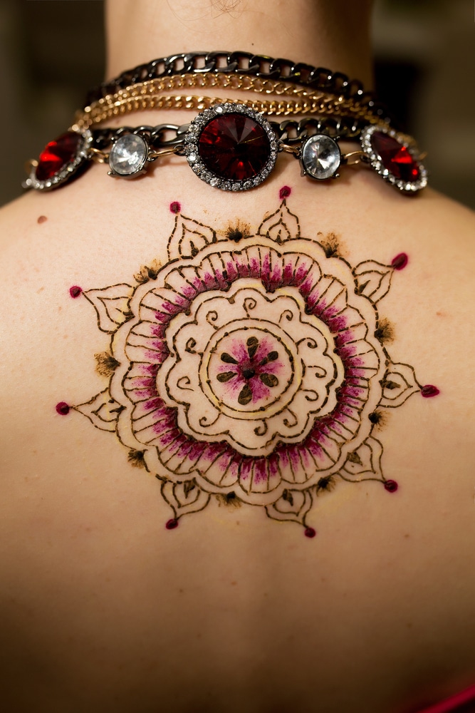 henna back tattoos on young women