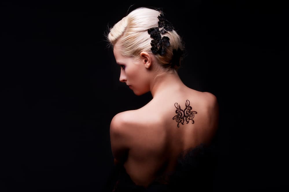 middle back or spine tattoos on model women