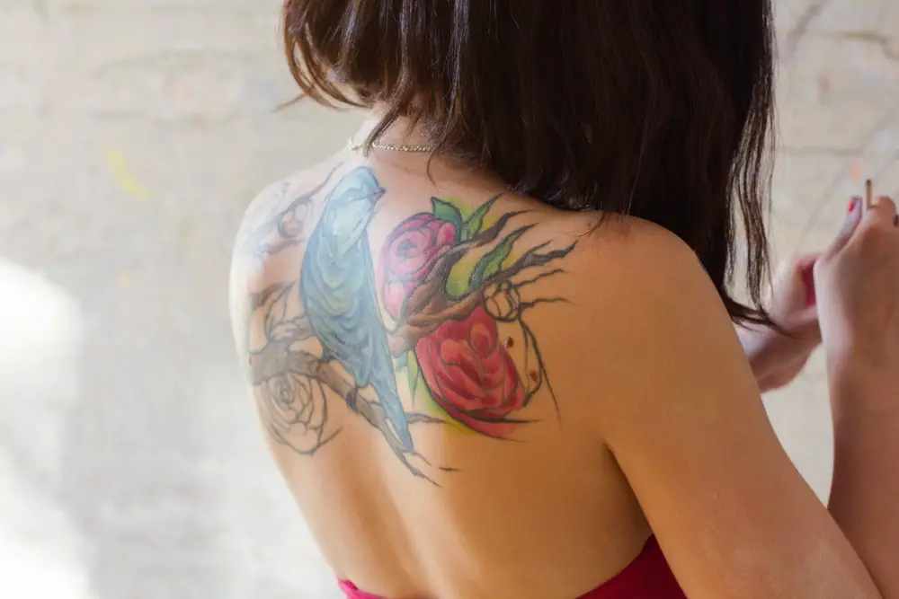 large colorful back tattoo on young women