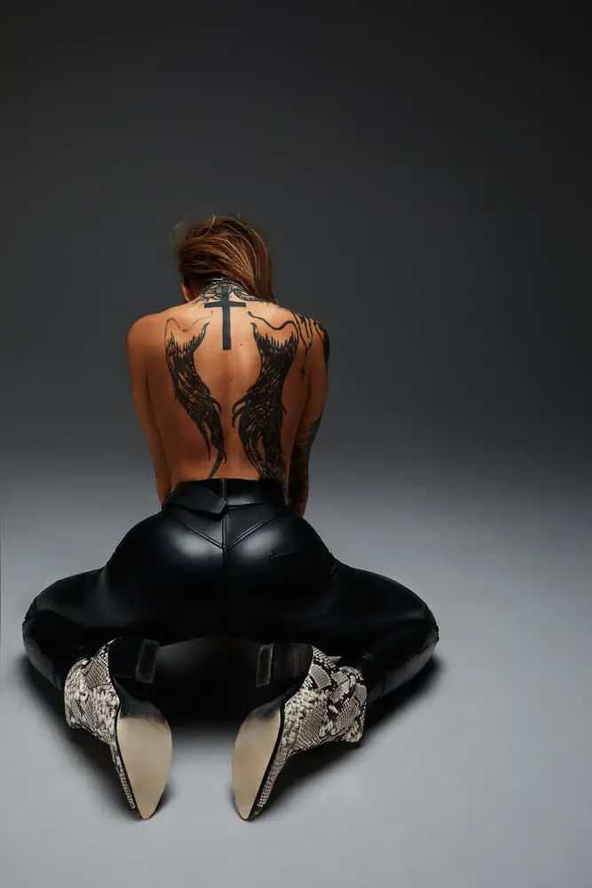 two black back tattoos on fit women