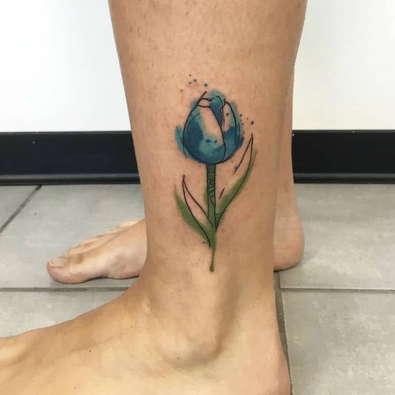 Watercolor tulip tattoo on the bicep