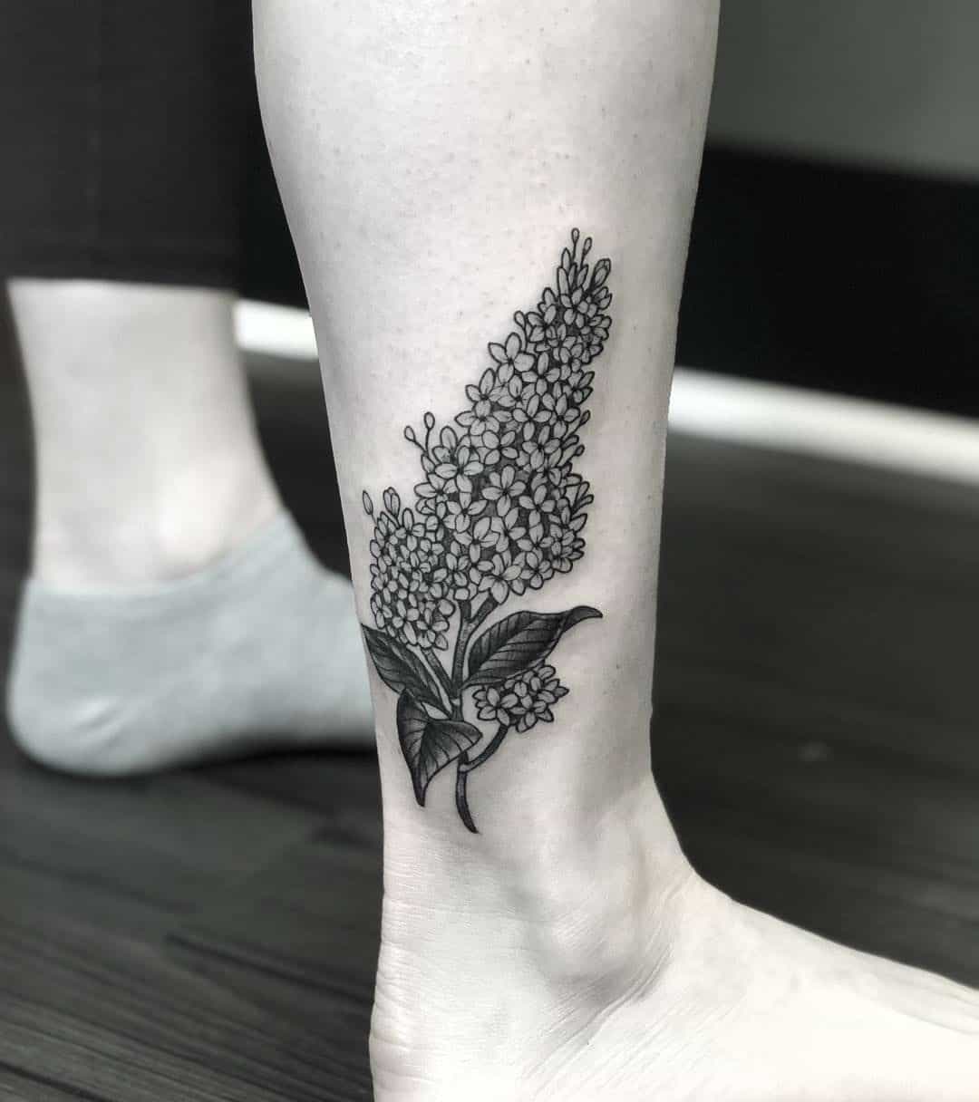 Watercolor lilac flowers tattoo on the ankle