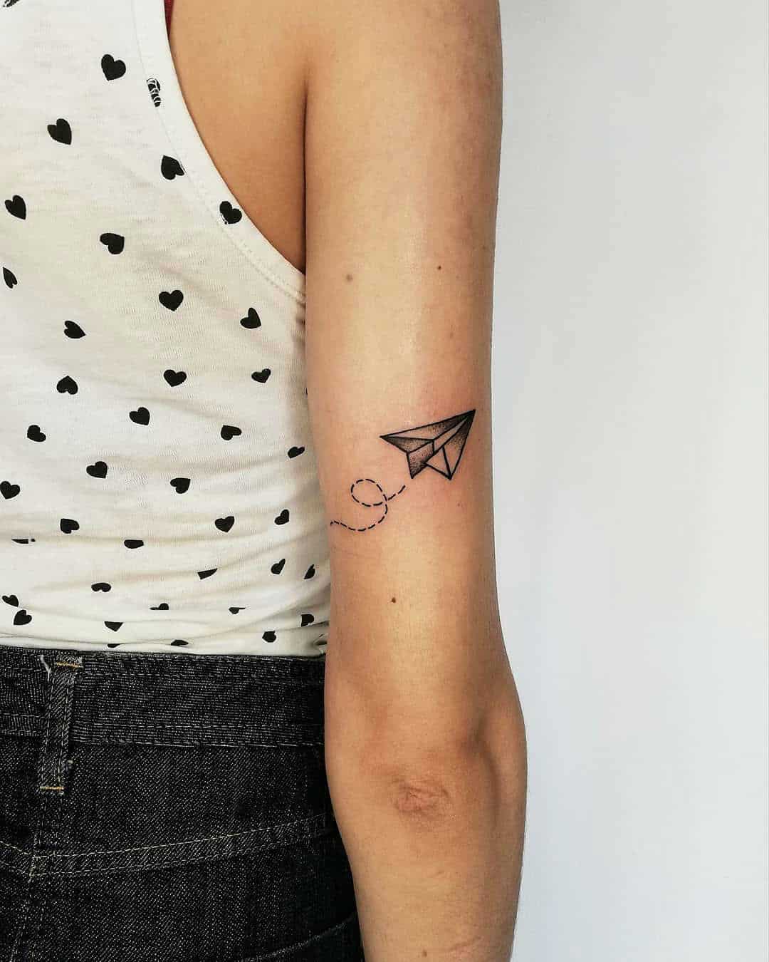Paper airplane tattoo done on the forearm watercolor