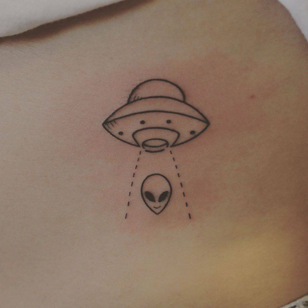 UFO tattoo on the left upper arm