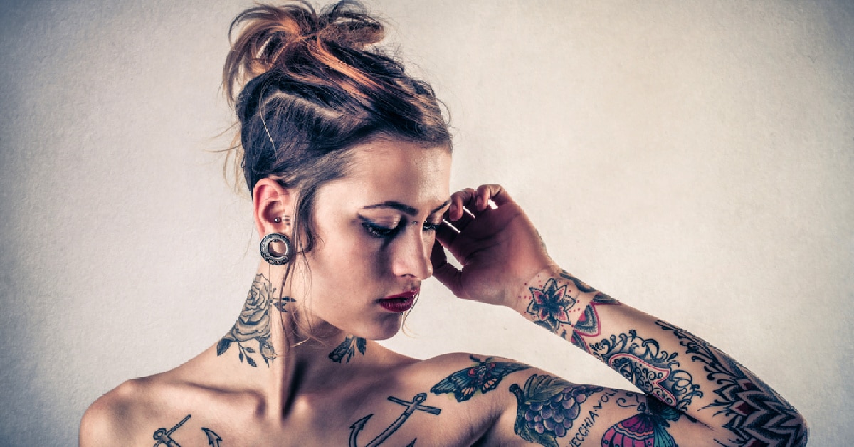 beautiful women wiht arm chest and neck tattoos