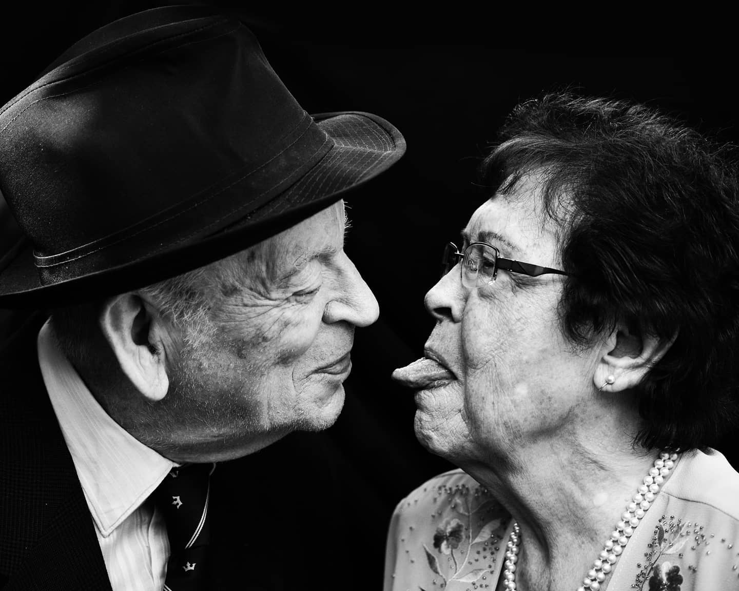 an old couple teasing each other in black and white photo