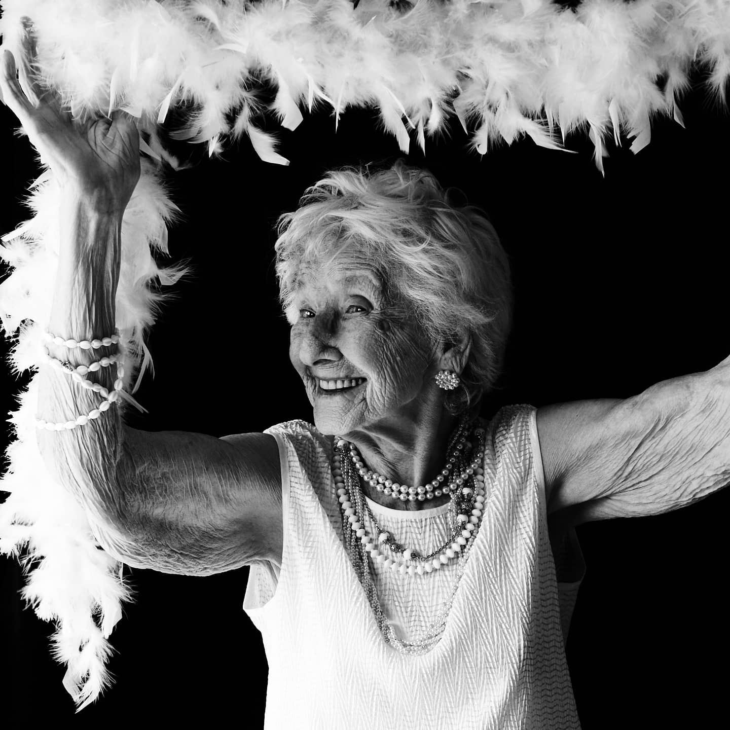 an elderly woman having fun in black and white photo