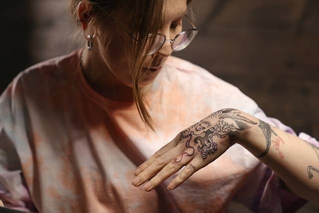 girl with new hand tattoo