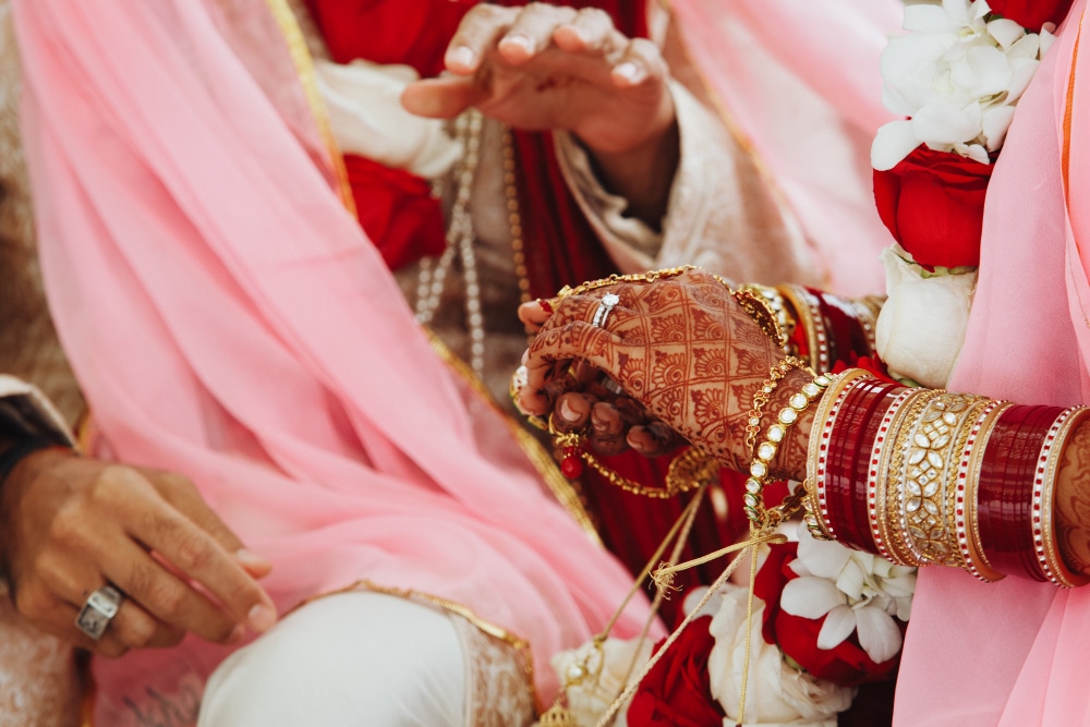 indian bride and groom with dark red henna