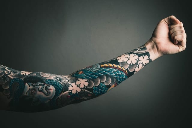 japanese arm tattoo design on strong man