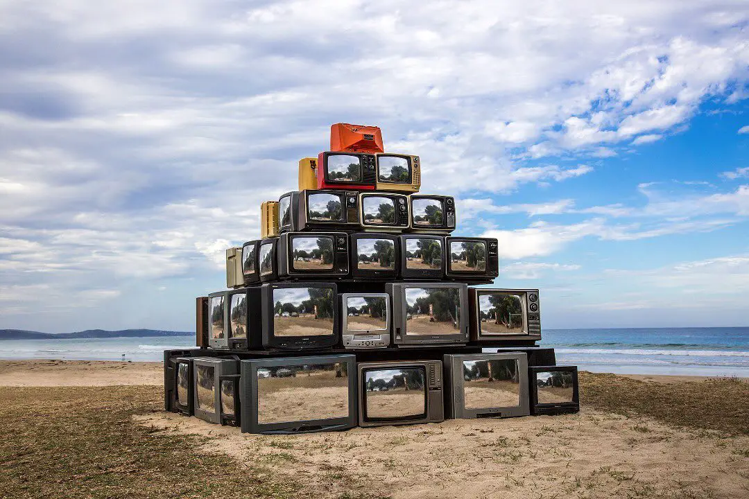 a collection of vintage televisions made into an art installation