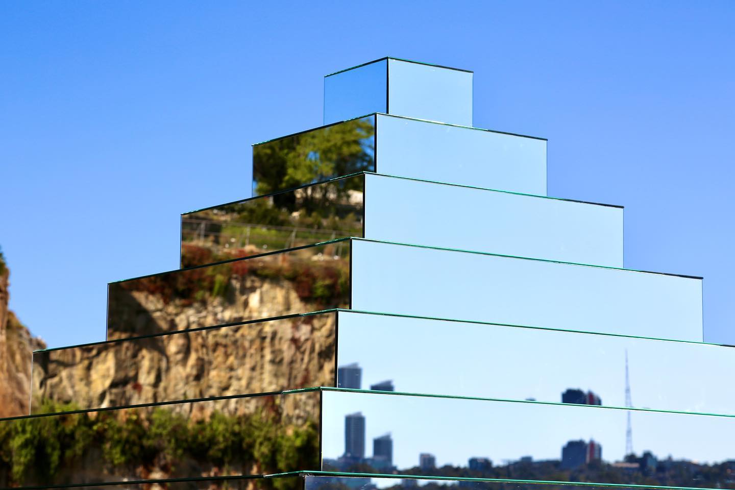 a staircase made with mirrors reflecting the 360 degrees view of the outdoors