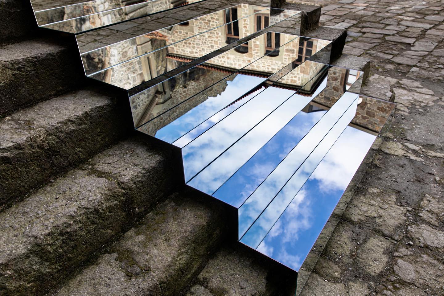 a photo of an art installation using mirrors reflecting the surroundings