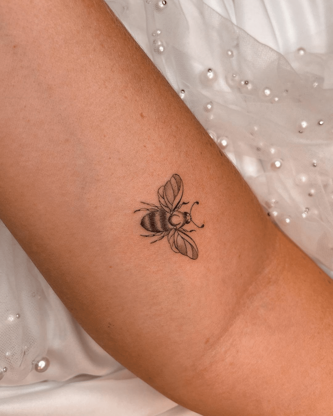 small bee arm tattoo for women
