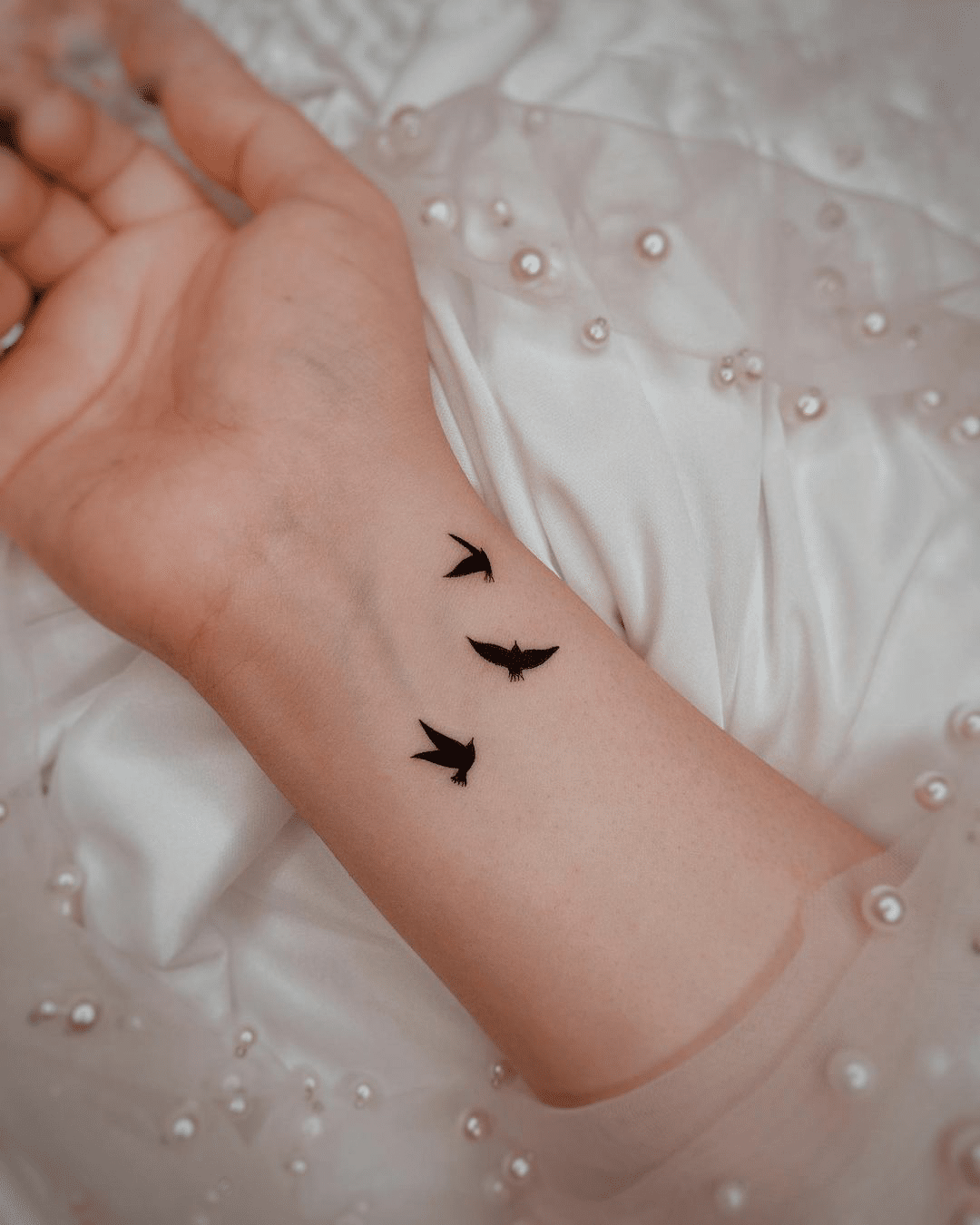 small bird tattoo design for women