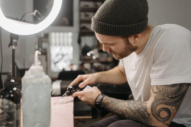 tattoo artist preparing tattoo equipment