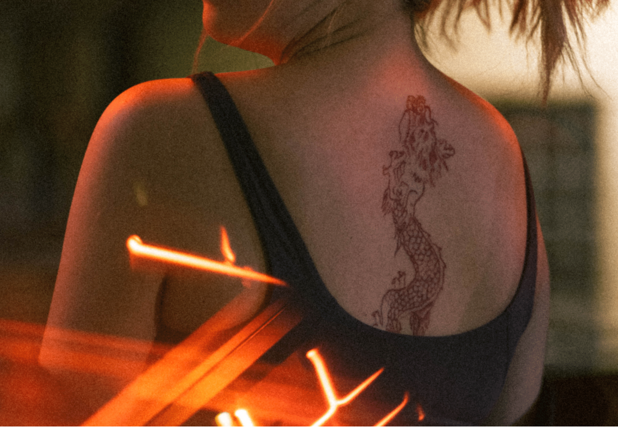 a woman with dragon tattoo on her back
