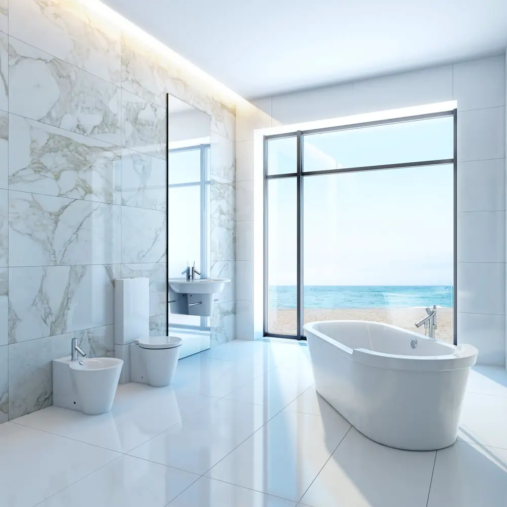 white marbled wall with freestanding acrylic tub and panoramic window overlooking the sea