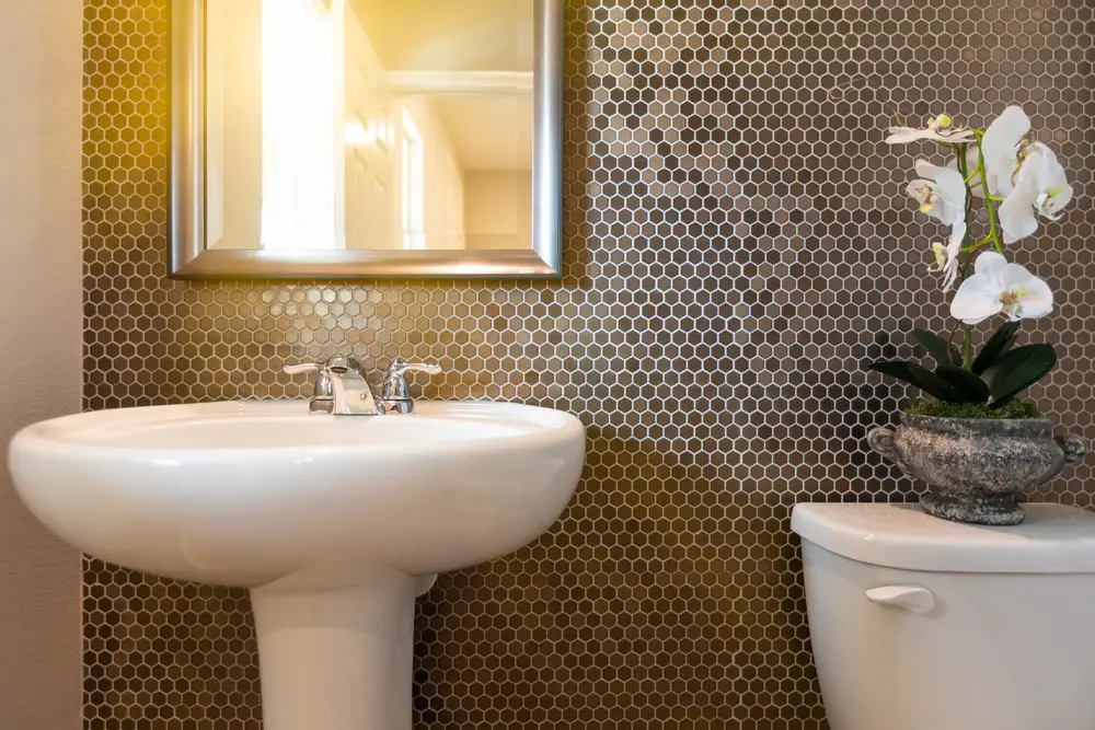mosaic tiled walls with pedestal lavatory