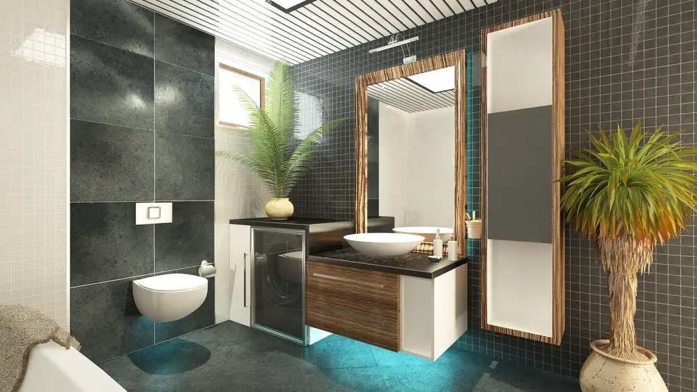 a luxurious bathroom design with dark gray mosaic tiles on the wall with dark wood accents and potted palm plants