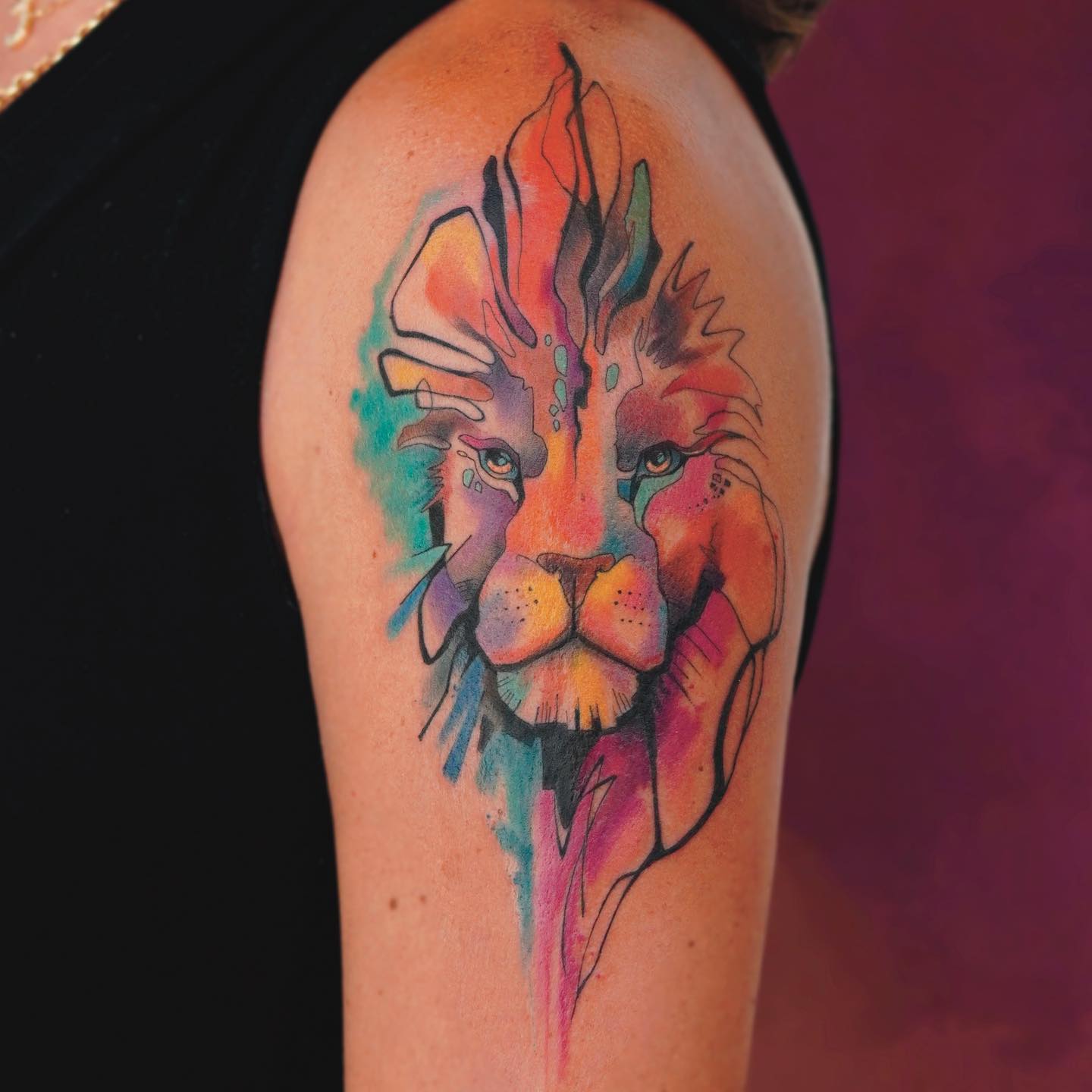 colorful lion tattoo on the arm