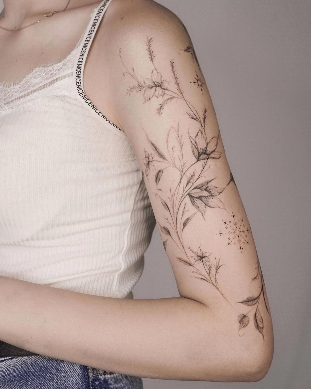 feminine flower tattoo on the arm