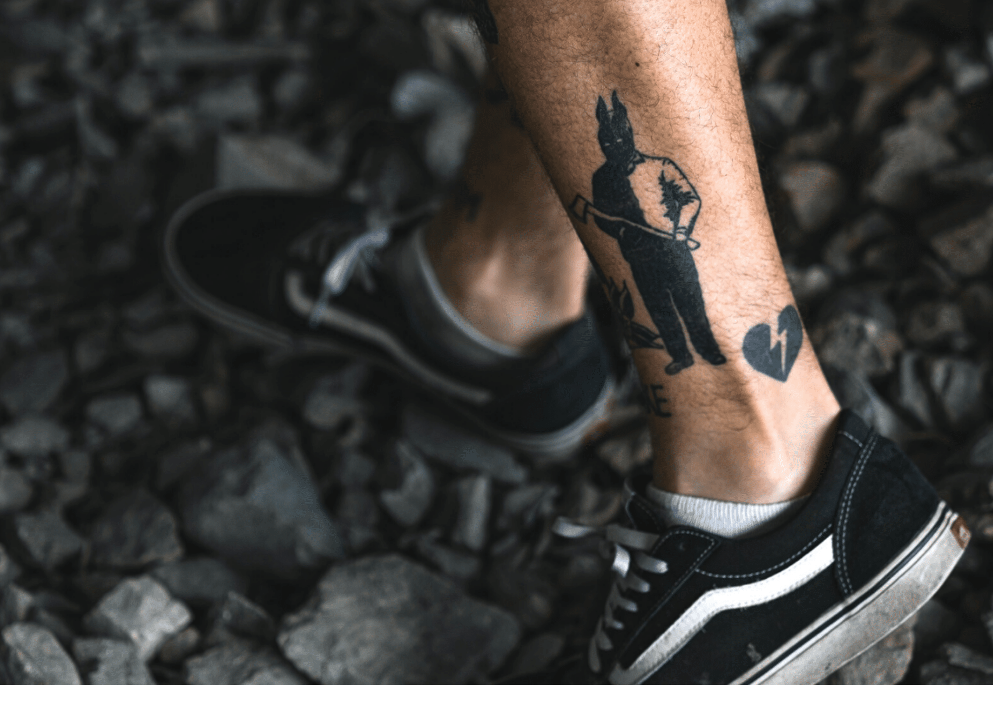 a guy with bold ankle tattoos