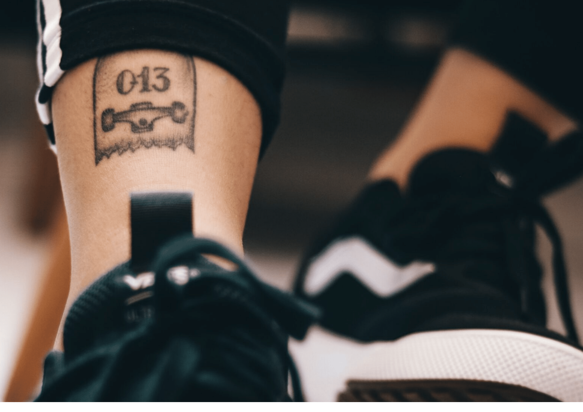 a person with skateboard trucks ankle tattoo