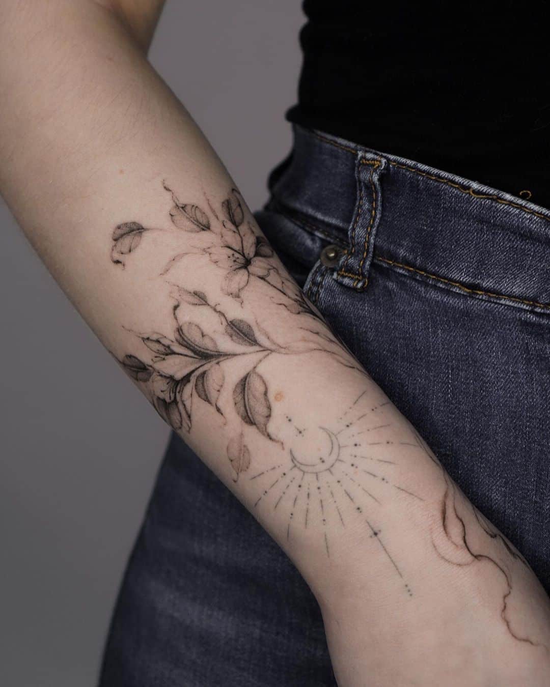 flower tattoos on the forearm of a woman
