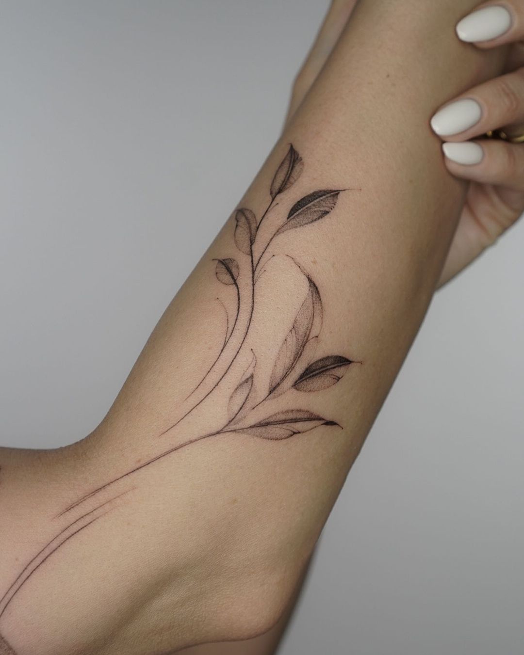 beautiful ornamental and flower tattoo on the forearm of a woman