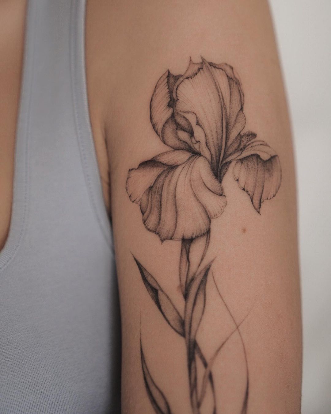 detailed flower tattoo on the upper arm