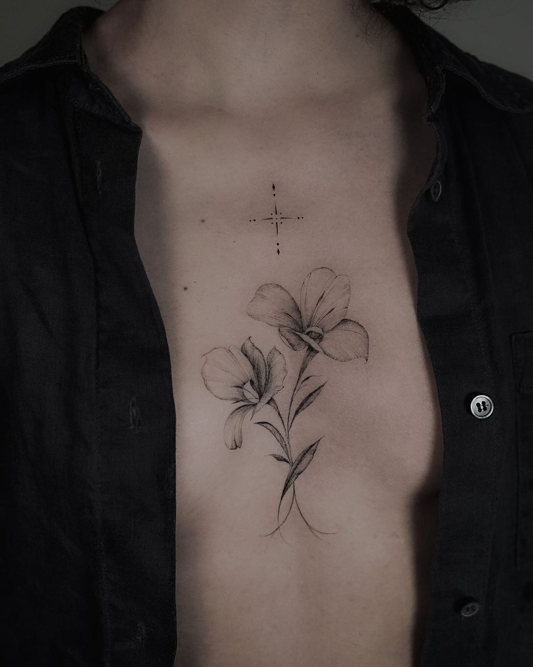 intricate flower tattoo on the chest of a woman