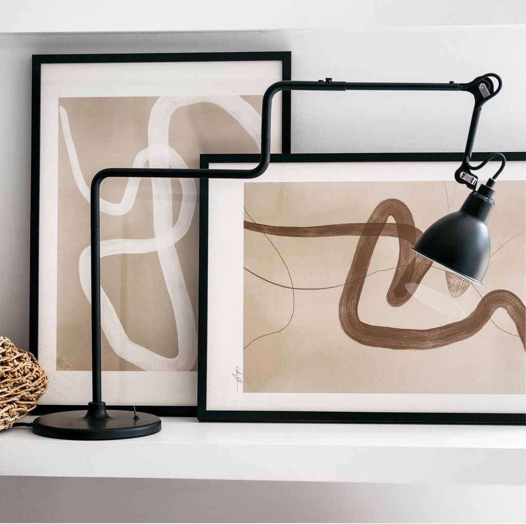 a picture of a modern lamp and abstract painting