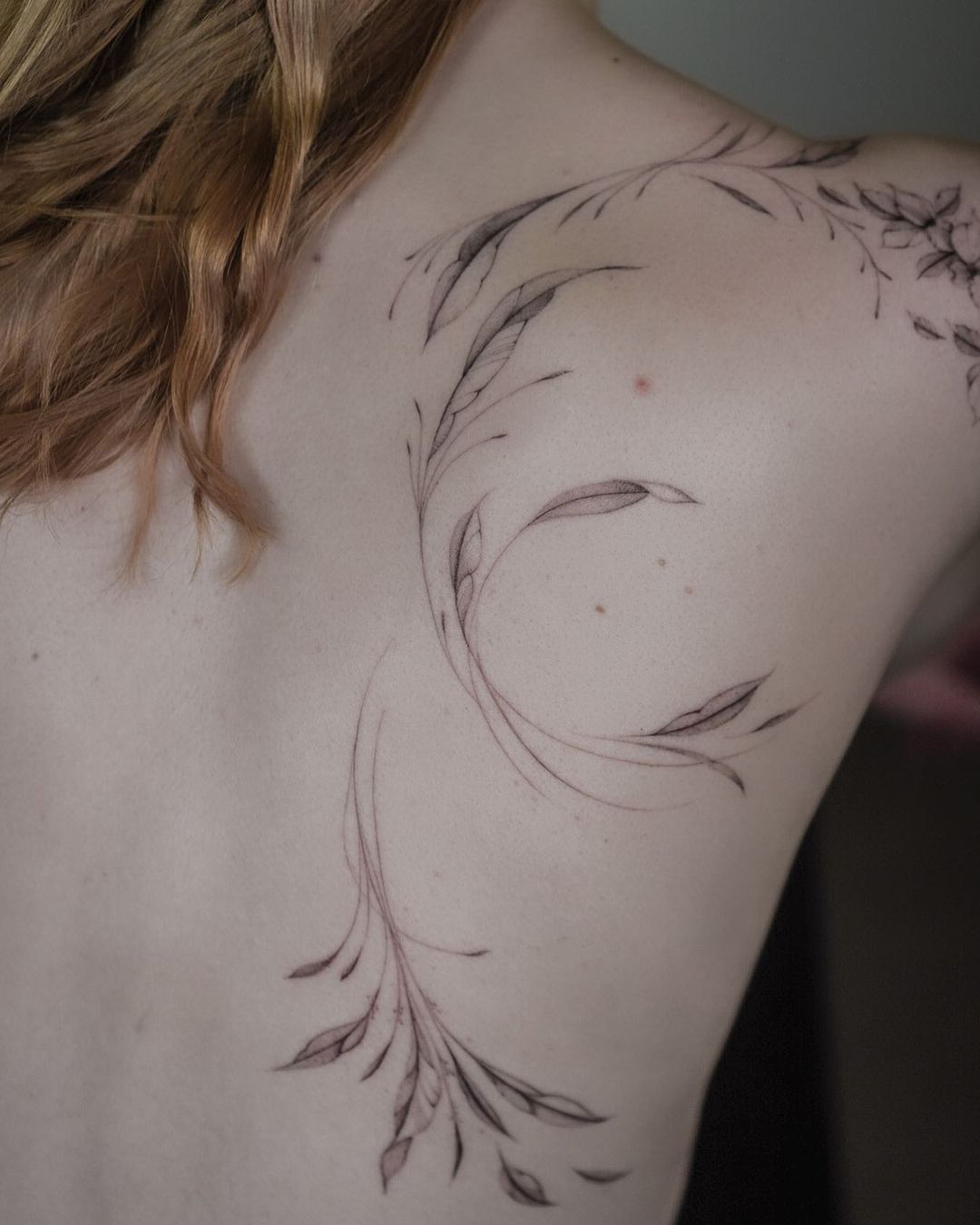 elegant flower tattoos on a womans back