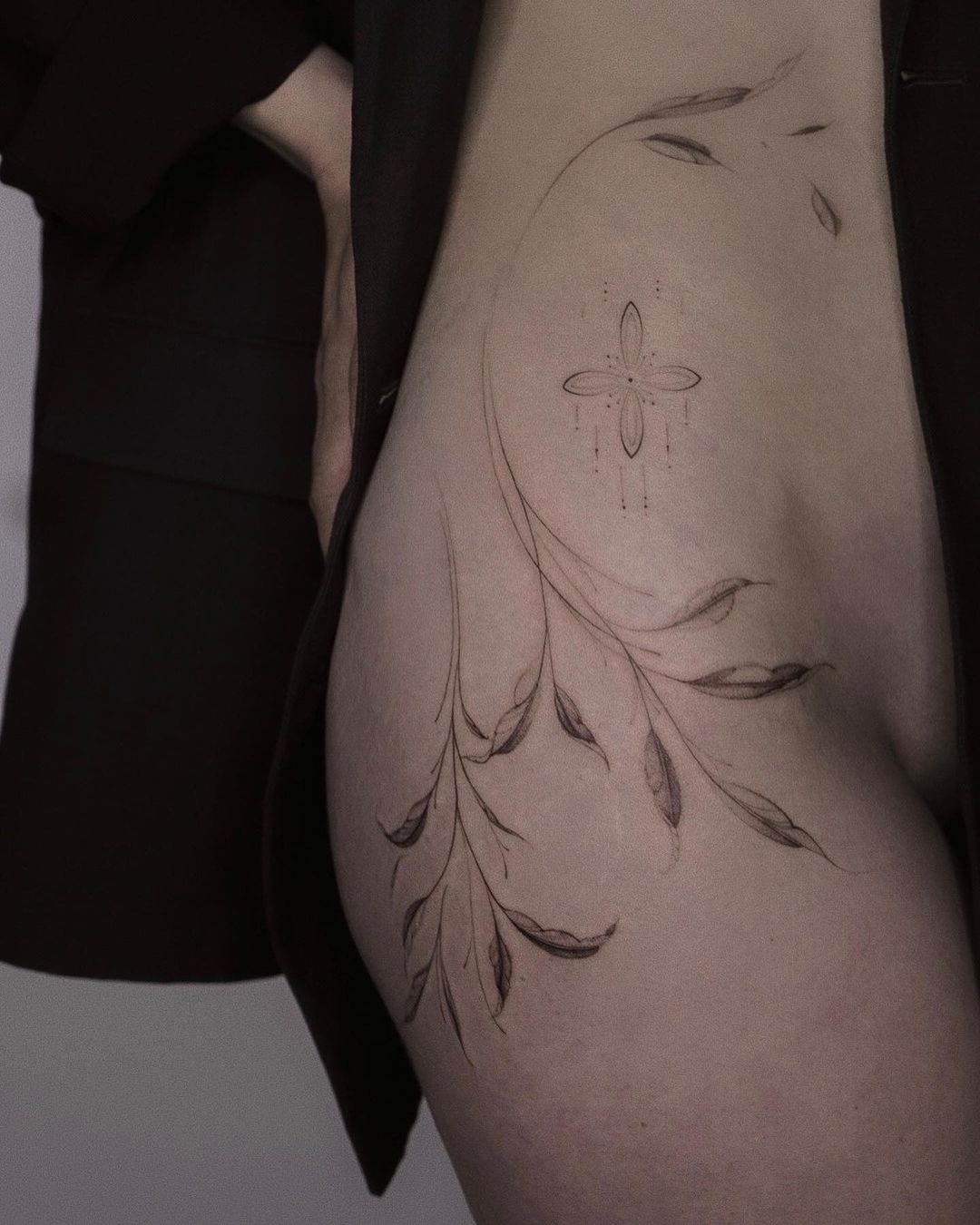 elegant thigh flower tattoo on a woman