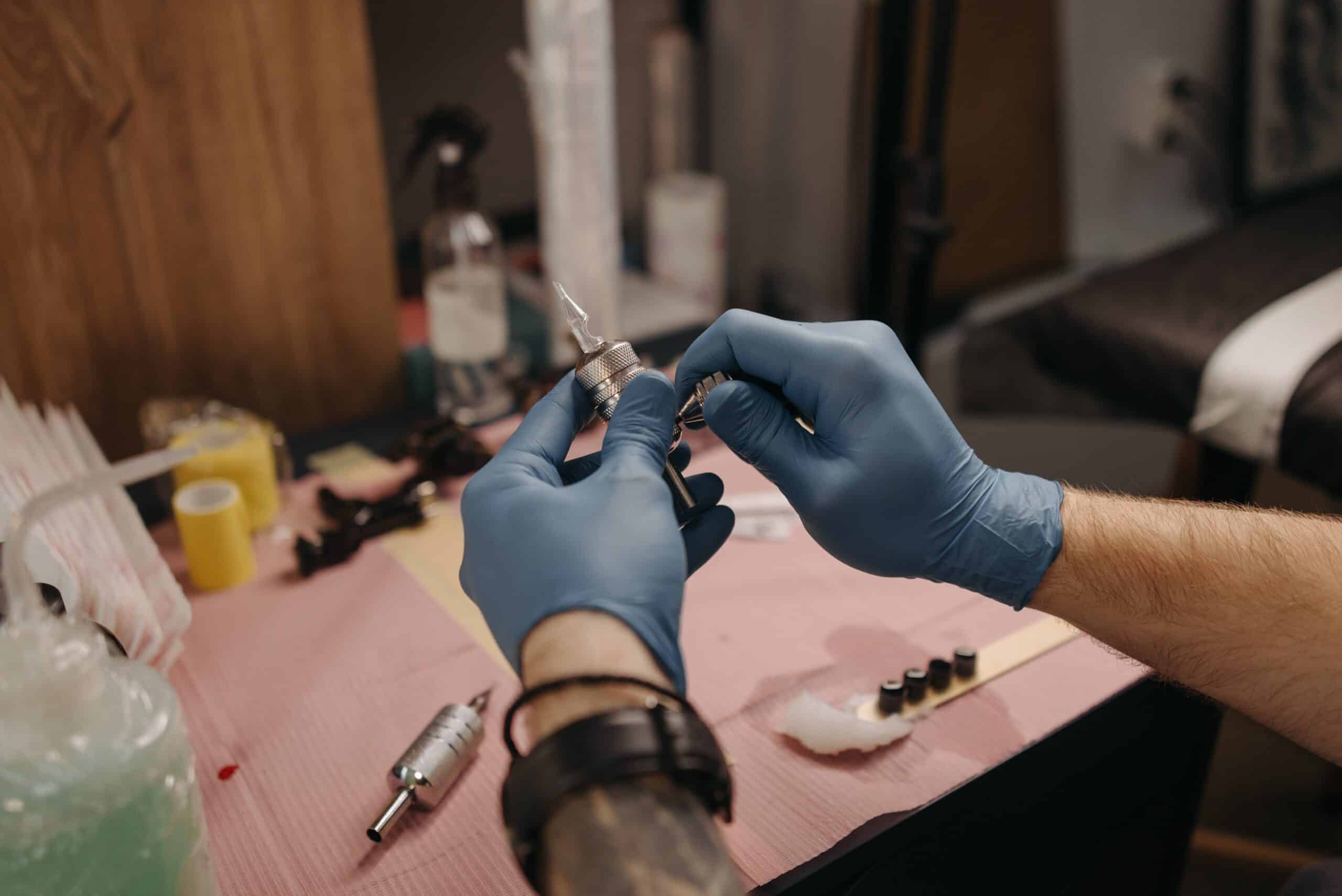 tattoo artist preparing tattoo equipment