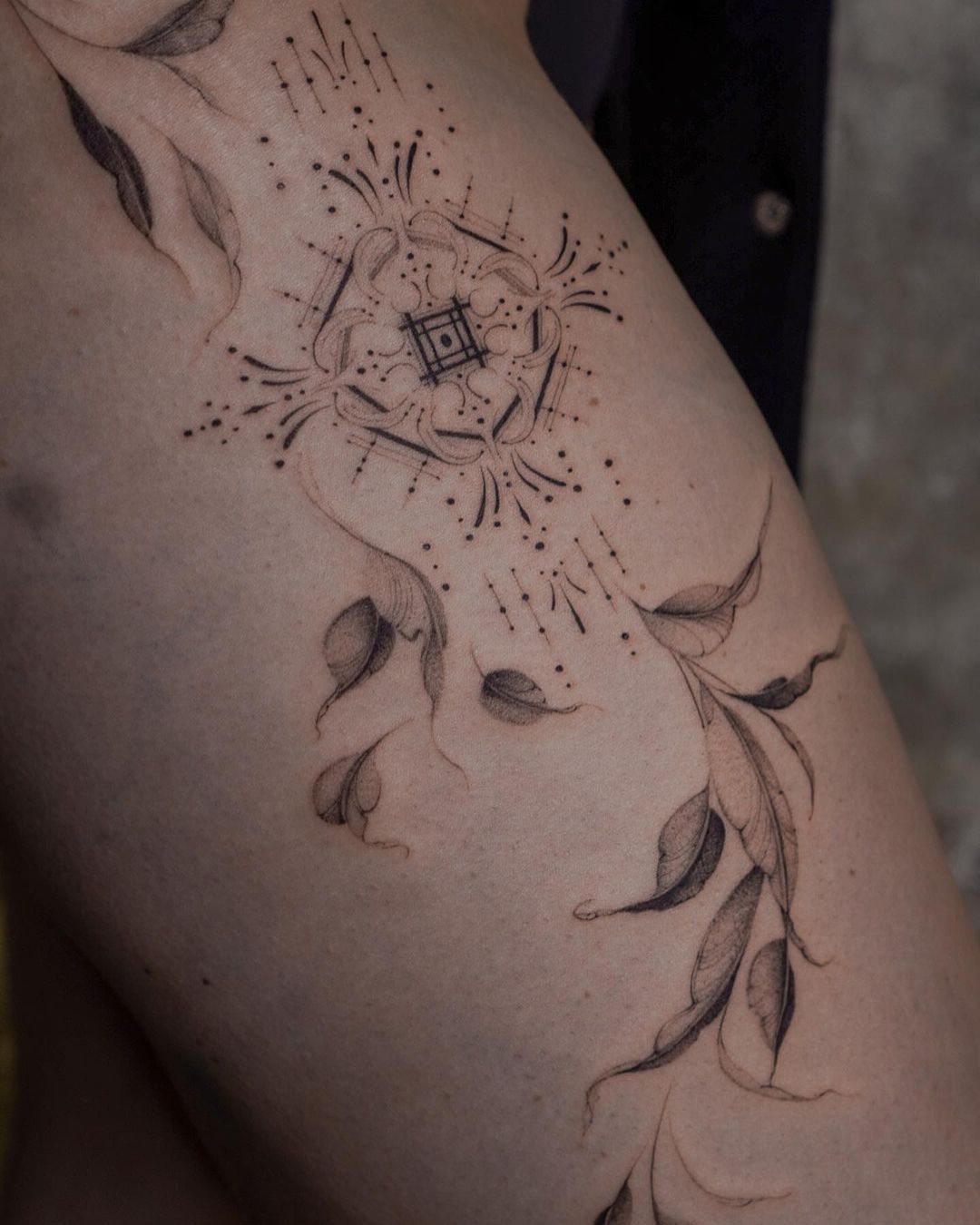 abstract flower tattoo on a womans leg