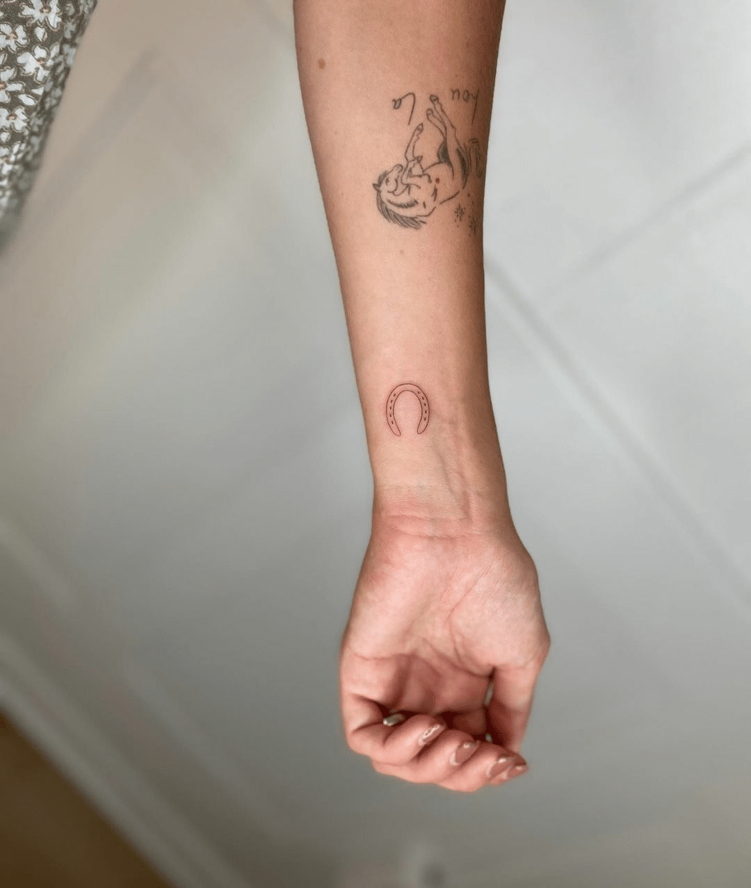 small horse shoe tattoo for women