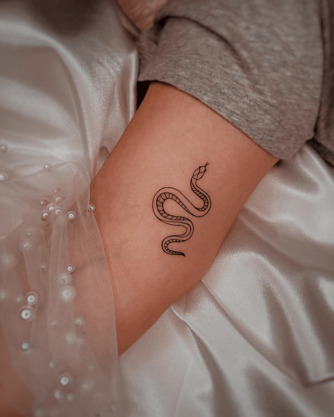 small snake arm tattoo