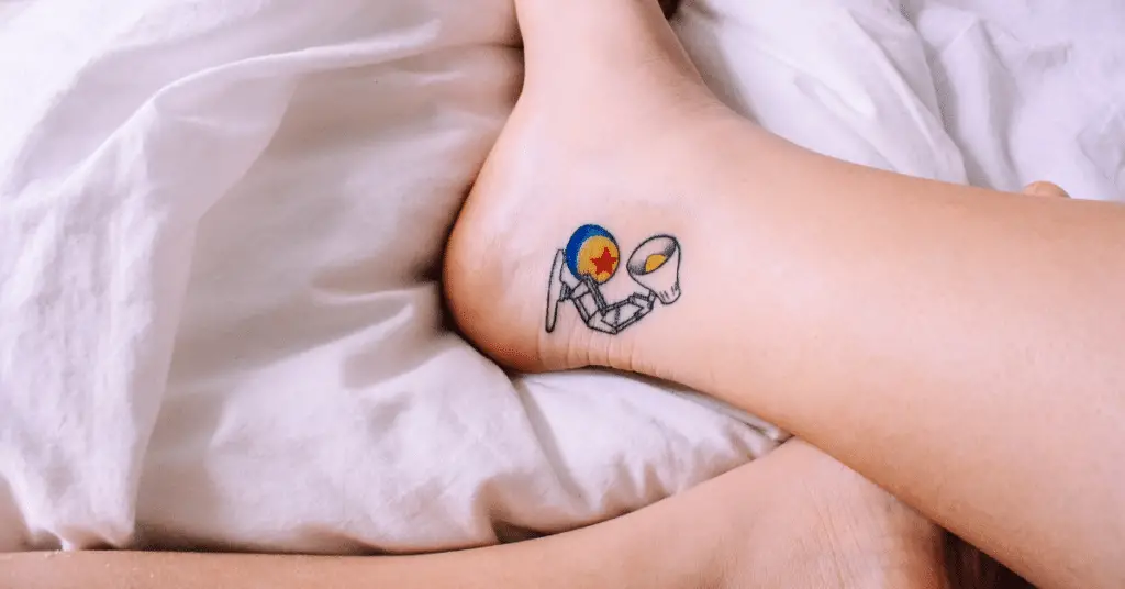 a colorful lamp ankle tattoo