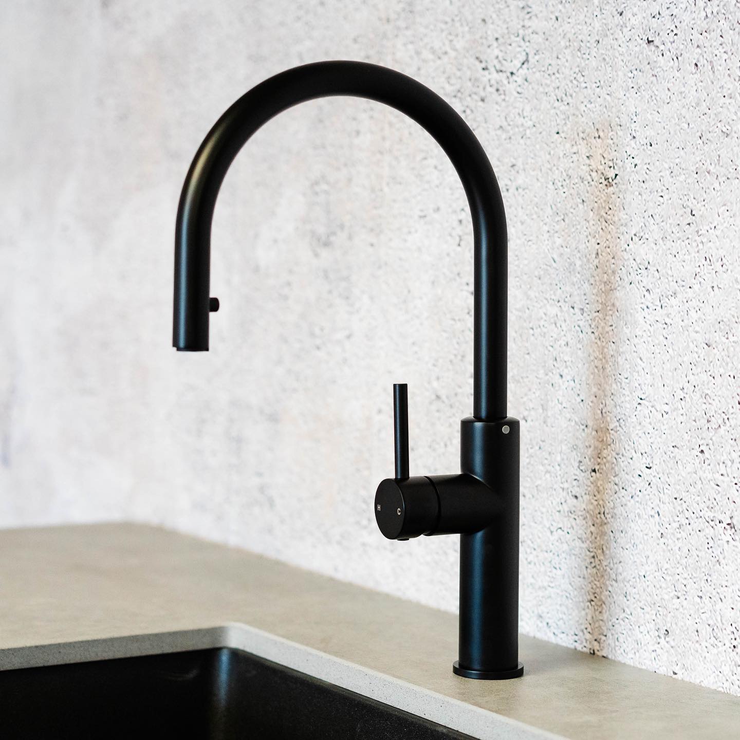 a matte black kitchen faucet designed with slick sophisticated look