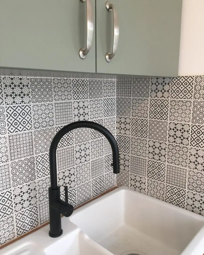 matte black kitchen faucet with black and white machuca wall tiles