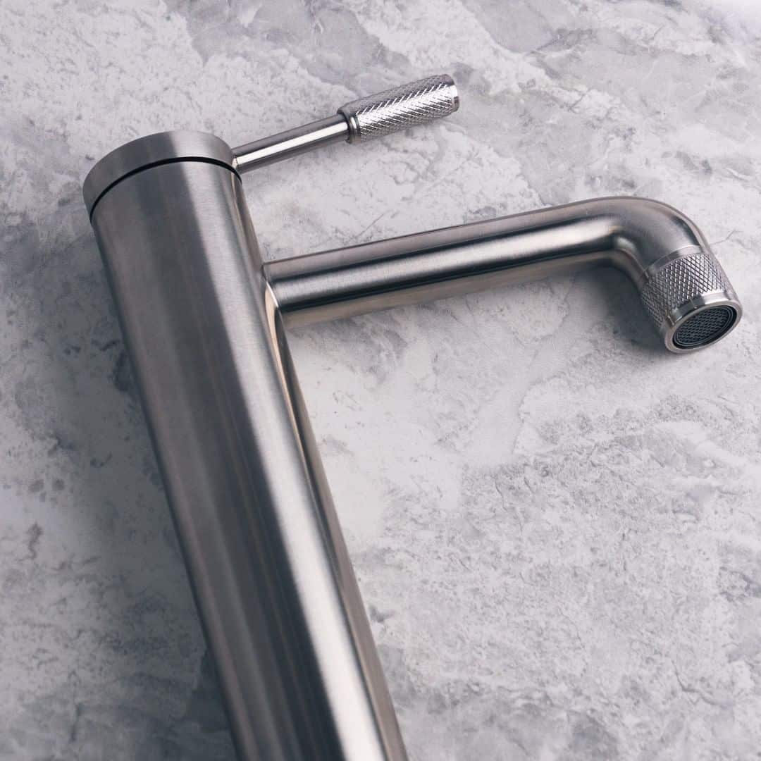a chrome finished kitchen faucet with knurled details