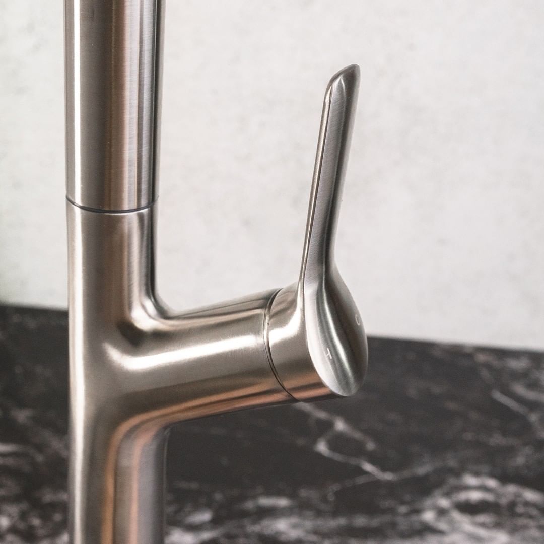 a close up image of a chrome finish kitchen faucets knob