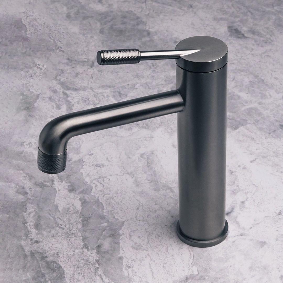 a close up picture of a kitchen faucet with knurled details