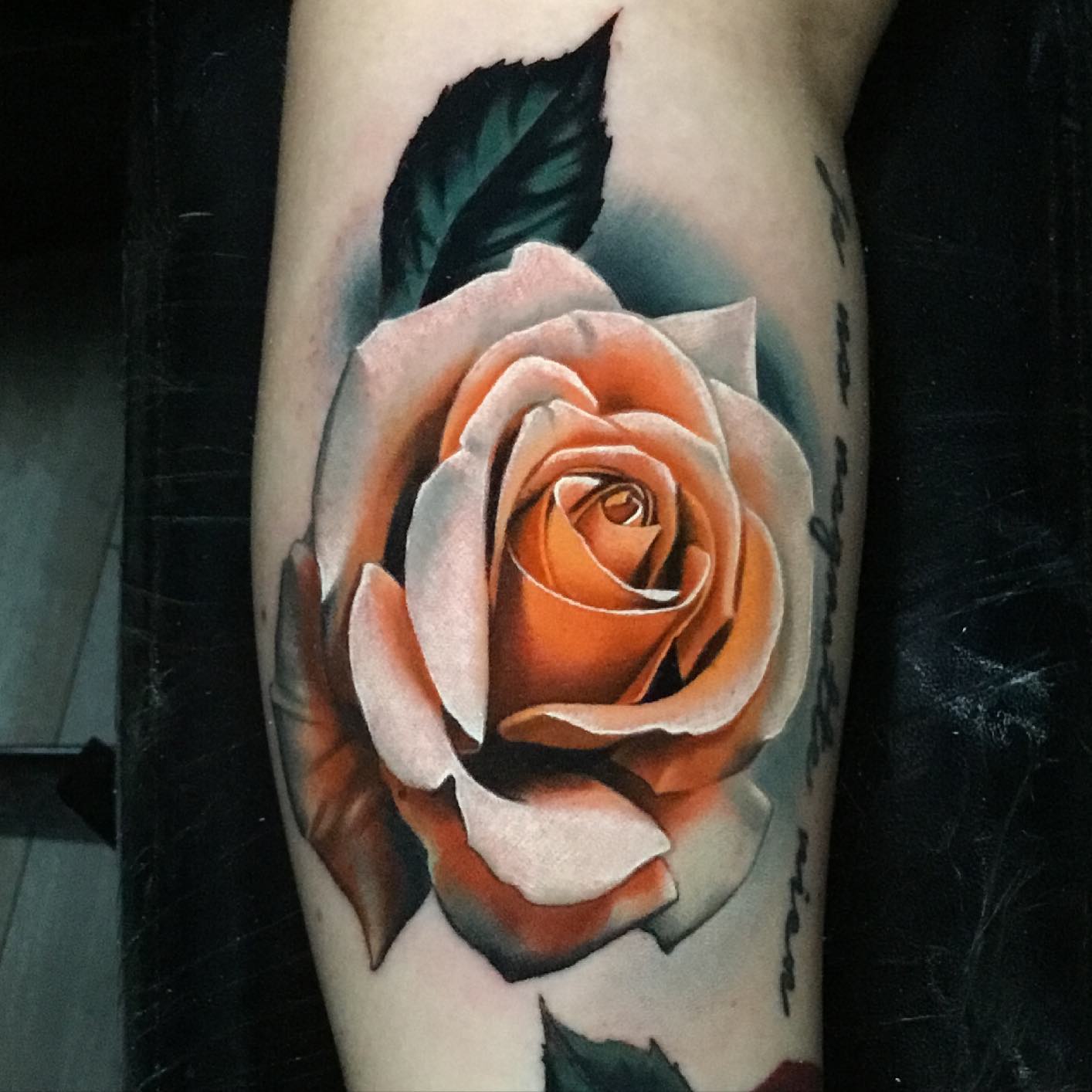 peach rose tattoo on a mans forearms