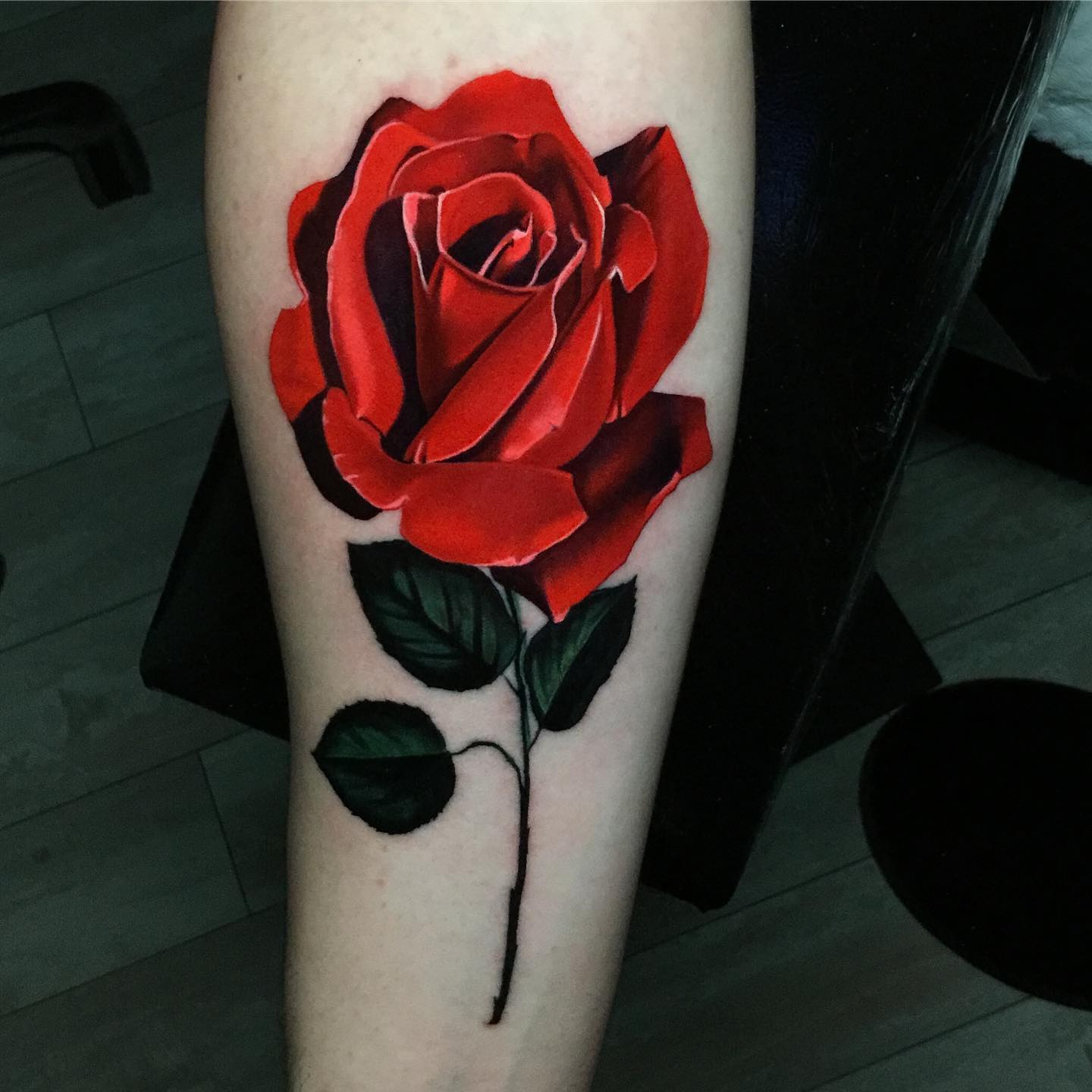 single red rose tattoo on the calves