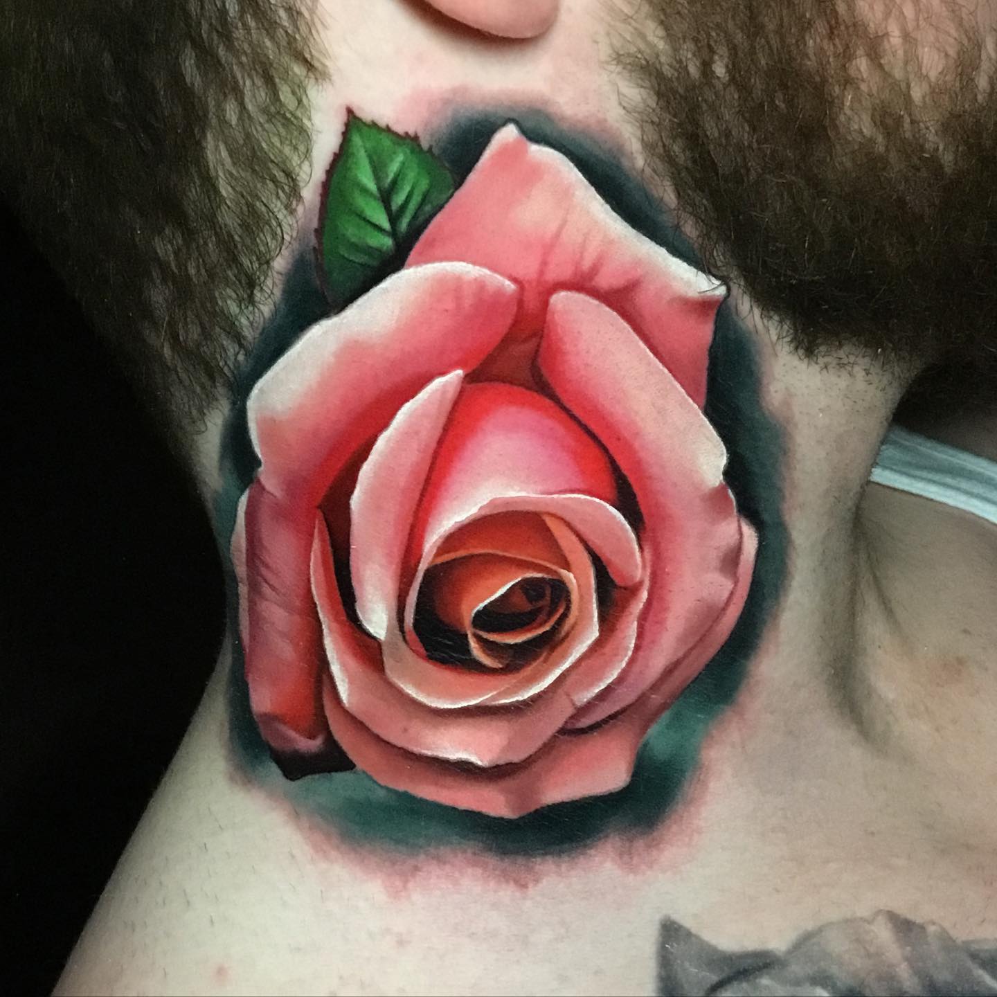 pink rose tattoo on mans neck
