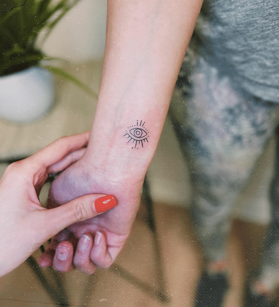 small all-seeing-eye line art tattoo for women